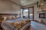 The main floor primary boasts a comfortable king bed and a gas fireplace 